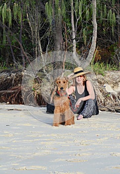 Stylish vogue mature senior woman on summer beach holiday with pet dog photo