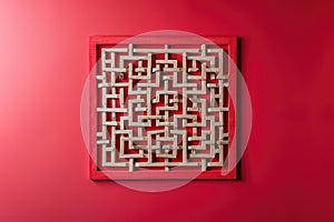 A stylish wall hanging featuring geometric maze patterns, isolated on a solid ruby red background