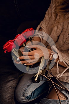 Stylish watch on woman hand and beautiful rosses in woman hands