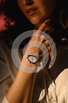 Stylish watch on woman hand. Golden analog wrist watch
