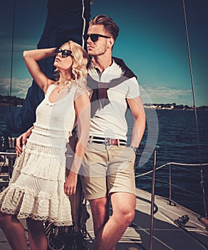 Stylish wealthy couple on yacht