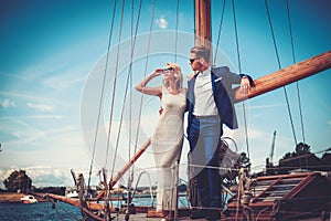 Stylish wealthy couple on a yacht photo