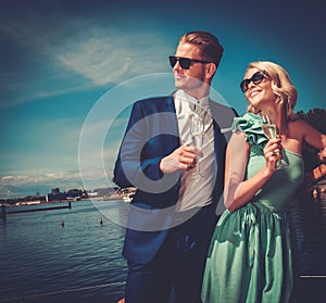 Stylish wealthy couple on a yacht