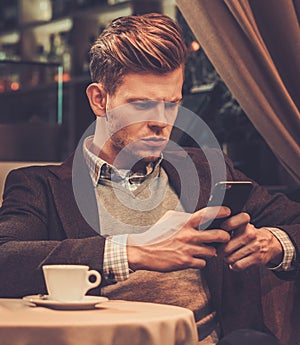 Stylish wealthy man using mobile phone