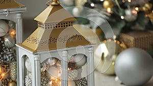 Stylish white christmas interior with decorated lanterns, fireplace, lanterns, lamps, candles, bumps. Comfort home with