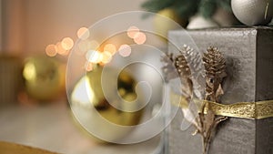 Stylish white interior with handmade gifts and presents decorated with ribbons and bumps under the Christmas tree