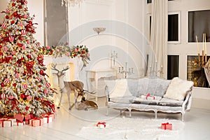 Stylish white living room interior with decorated Christmas tree, fireplace and sofa with pillows. Christmas at home.
