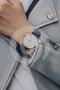 Stylish white watch on woman hand. Close-up photo