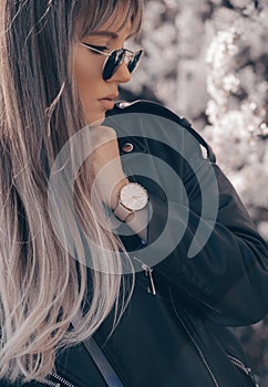 Stylish white watch on woman hand. Portrait of a gorgeous young woman