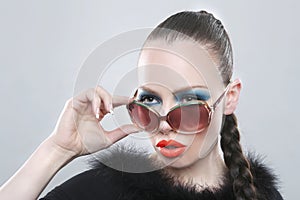 Stylish Woman With Beauty Makeup and Sunglasses