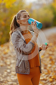 stylish woman in fitness clothes in park