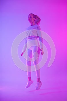 Stylish Woman Floating in Neon Light with Modern Vibe