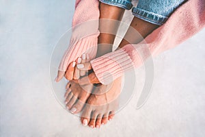 Stylish woman hands and feet with beautiful french manicure and pedicure