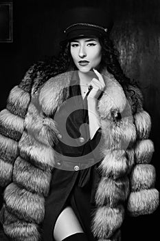 Stylish woman in jacket dress and fur coat