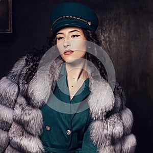 Stylish woman in jacket dress and fur coat