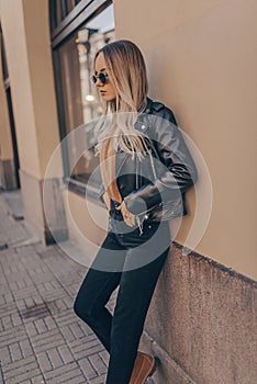 Stylish woman in jacket posing in outdoor photo