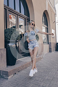 Stylish girl posing in the street, wearing shorts. Fashion summer photo photo