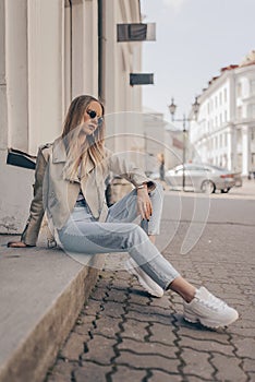 Stylish woman posing in the street, wearing sunglasses photo