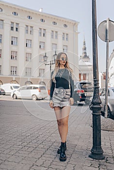 Stylish young blogger posing in the street, wearing sunglasses. Fashion summer photo photo