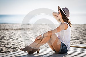 Stylish woman at the summer beach in a hot day