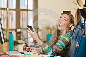 Stylish Woman Using her Phone and Laughing