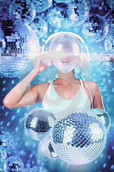 A stylish woman wearing a tank top have a large disco ball in replaced her face, surrounded by multiple shiny disco balls against