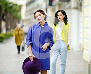 Stylish women model 20-25 years old on a square in a European city