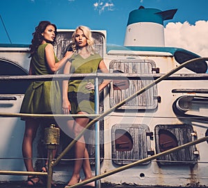 Stylish women on old boat