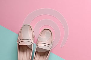 Stylish women shoes on pink and blue background. Copy space