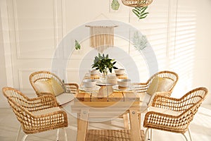 Stylish wooden dining table and chairs in room