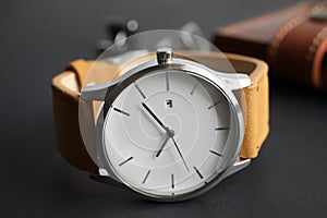 Stylish wrist watch on dark background.