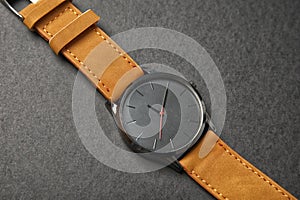 Stylish wrist watch on dark background.