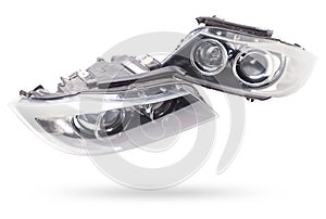 Stylish xenon headlight of a German car - optical equipment with a lamp inside on a white isolated background. Spare part for auto