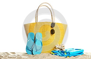 Stylish yellow bag and beach accessories on sand