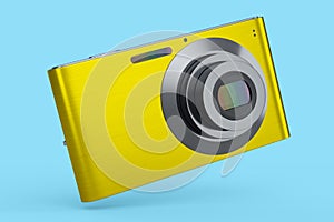 Stylish yellow compact pocket digital camera isolated on blue background