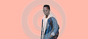 Stylish young african man model wearing denim jacket, backpack isolated on pink background, blank copy space