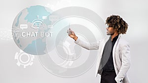 Stylish young black businessman holding smartphone, chatbot icon, collage