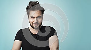 Stylish young brunette bearded man isolated on color background.