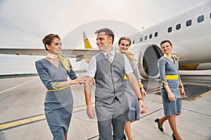 Stylish young cabin crew at the airdrome