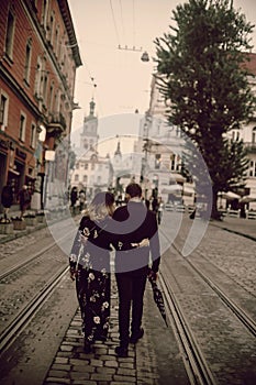 Stylish young couple walking in Vienna on vacation, fashionable