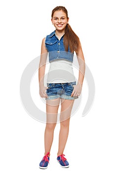 Stylish young girl in a jeans vest and denim shorts. Street style teenager, lifestyle, isolated on white background