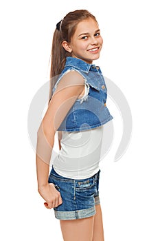 Stylish young girl in a jeans vest and denim shorts. Street style teenager, lifestyle, isolated on white background