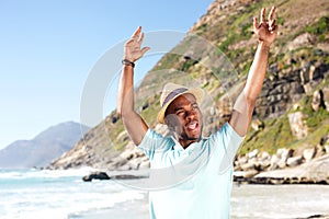 Stylish young guy with hat enjoying at the beach