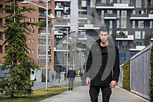 Stylish Young Handsome Man in Black Coat Standing in City