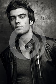 Stylish young man in black leather jacket. Contrast black and white