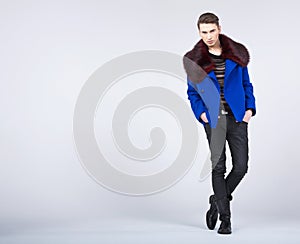 Stylish young man in fashion pose