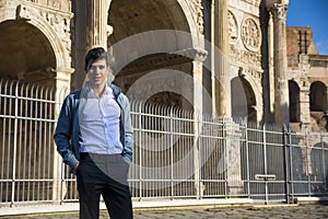 Stylish young man in front of Arco di Costantino, Rome, Italy photo