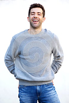 Stylish young man posing against white wall