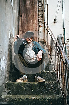 Stylish Young Man Sitting on Urban Stairs