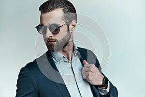 Stylish young man in a suit and bow tie. Business style. Fashionable image.